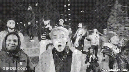 Black And White People Standing Around Christmas Tree GIF