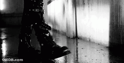 Black And White Person In Black Boots Walking In Rain GIF