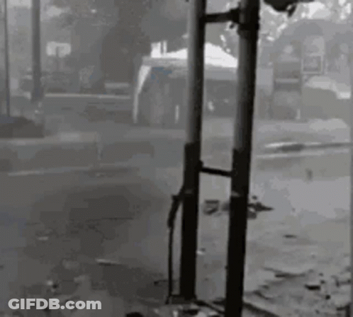 Black And White Person Next To Pole GIF