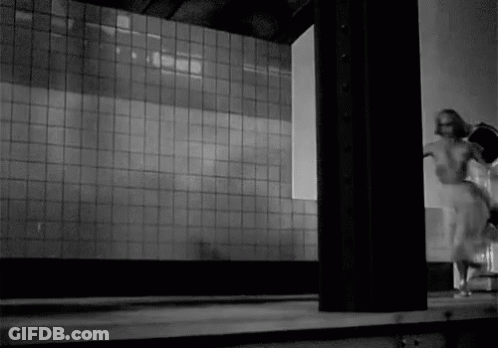 Black And White Person Standing In Front Of Wall GIF