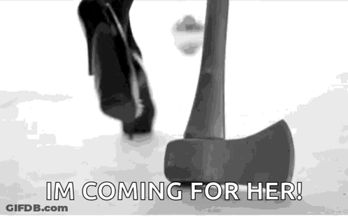Black And White Person Standing Next To Large Axe GIF