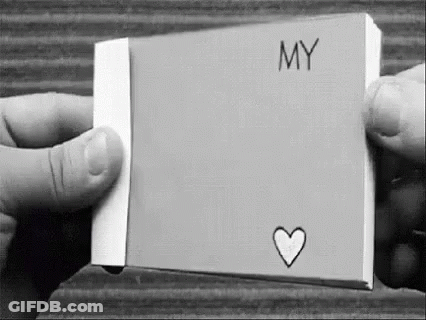 Black And White Photo Holding Paper With Heart GIF