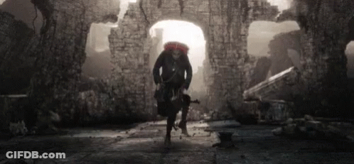 Black And White Photo Man Carrying Backpack And Gun In Tunnel GIF