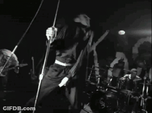 Black And White Photo Of Band Playing Concert GIF