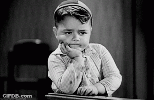 Black And White Photo Of Boy With Hand On Chin GIF
