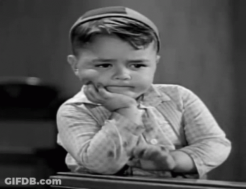 Black And White Photo Of Boy With Hand On Face GIF