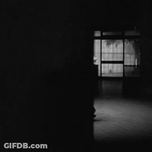 Black And White Photo Of Couple Dancing In Dark Room GIF