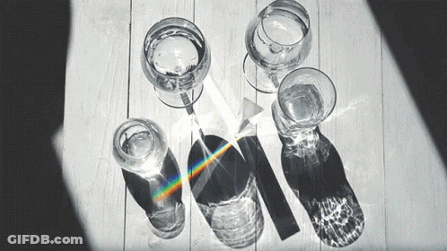 Black And White Photo Of Glasses Of Water And A Prism GIF