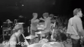 Black And White Photo Of Group On Stage GIF