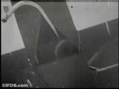 Black And White Photo Of Hose Coming Out Of Pipe On Wall GIF