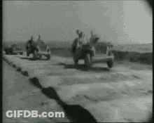 Black And White Photo Of Jeep Drivers Driving Down Road GIF