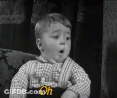 Black And White Photo Of Little Boy With Oh On Overalls GIF
