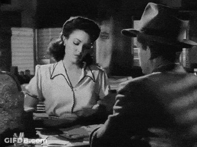Black And White Photo Of Man And Woman At Table GIF