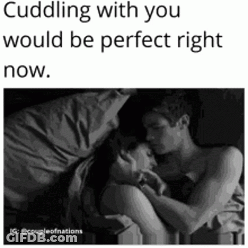 Black And White Photo Of Man And Woman Hugging In Bed GIF