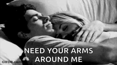 Black And White Photo Of Man And Woman Hugging In Bed GIF