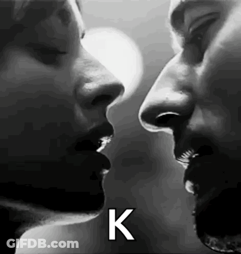 Black And White Photo Of Man And Woman Kissing GIF