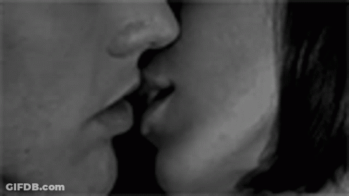 Black And White Photo Of Man And Woman Kissing GIF