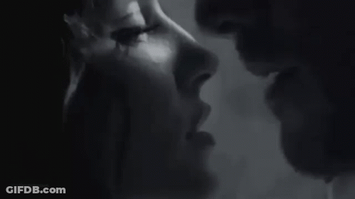 Black And White Photo Of Man And Woman Kissing GIF