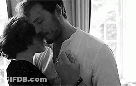 Black And White Photo Of Man And Woman Kissing GIF