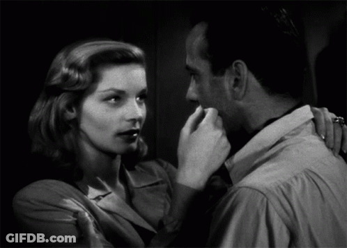 Black And White Photo Of Man And Woman Looking At Each Other GIF