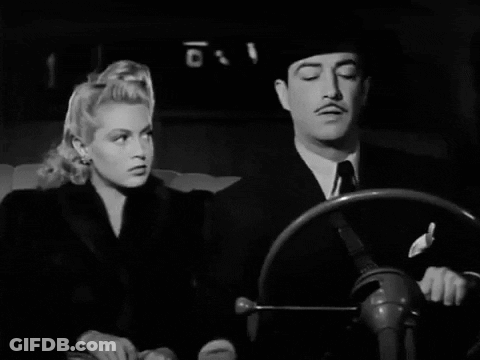 Black And White Photo Of Man And Woman Looking At Each Other GIF