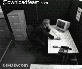Black And White Photo Of Man At Desk With Downloadfeast.com GIF