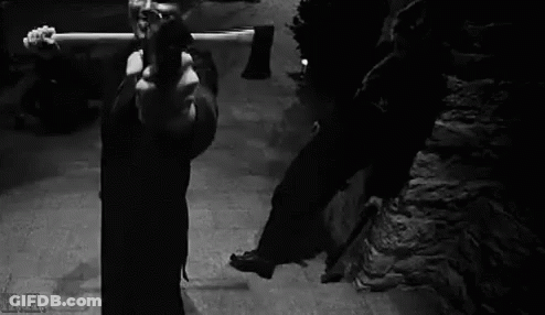 Black And White Photo Of Man Holding Gun GIF