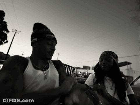 Black And White Photo Of Man In Beanie And Woman In Bandana GIF