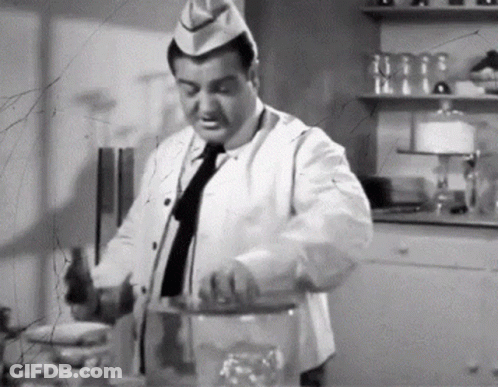 Black And White Photo Of Man In Chef Hat And Tie GIF