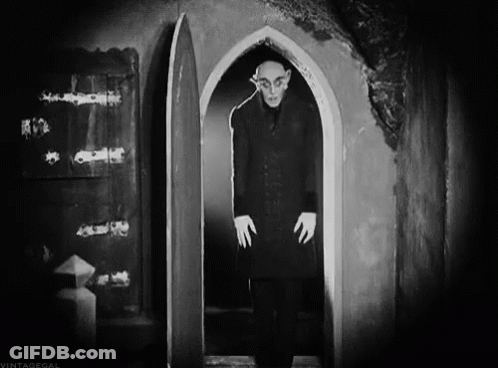 Black And White Photo Of Man In Doorway GIF