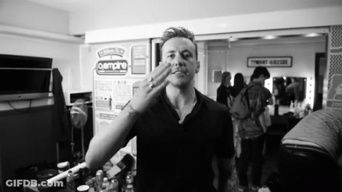 Black And White Photo Of Man In Front Of Aempire Sign GIF
