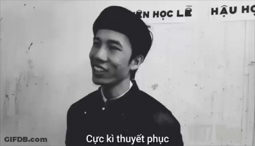 Black And White Photo Of Man In Front Of Cục Kỳ Thuyết Phục Sign GIF