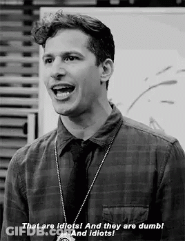 Black And White Photo Of Man In Plaid Shirt And Tie Talking GIF