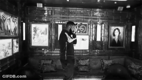 Black And White Photo Of Man In Room With Couch And Paintings GIF