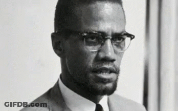 Black And White Photo Of Man In Suit And Tie With Glasses GIF