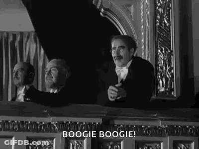Black And White Photo Of Man In Tuxedo Sitting In Balcony GIF