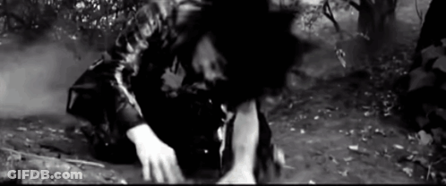 Black And White Photo Of Man Kneeling In Dirt GIF