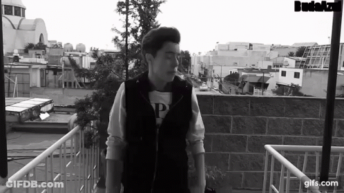 Black And White Photo Of Man On Balcony GIF