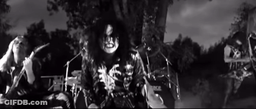 Black And White Photo Of Man Playing Drum Set Saying Rock GIF