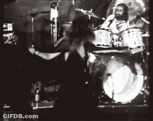 Black And White Photo Of Man Playing Drums In Band GIF