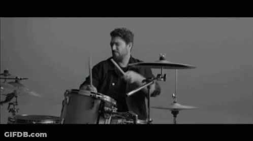 Black And White Photo Of Man Playing Drums GIF