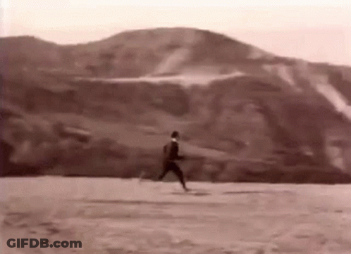 Black And White Photo Of Man Running On Dirt Field GIF