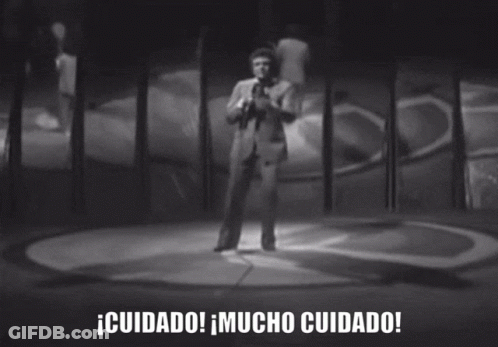 Black And White Photo Of Man Singing Into Microphone Cuidado Mucho Cuidado GIF