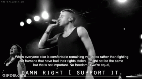 Black And White Photo Of Man Singing Into Microphone GIF