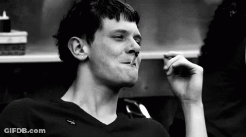 Black And White Photo Of Man Smoking Cigarette In Restaurant GIF