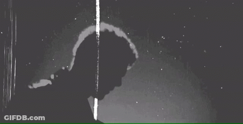 Black And White Photo Of Man Standing In Rain Looking Down GIF