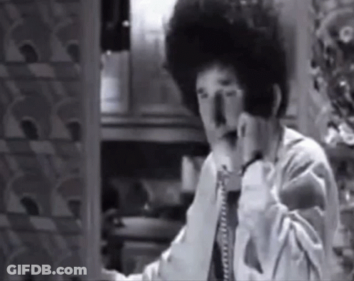Black And White Photo Of Man Talking On Telephone GIF