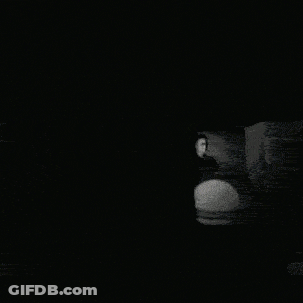 Black And White Photo Of People In Dark Room GIF