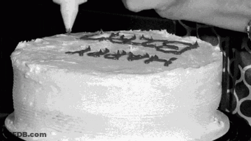 Black And White Photo Of Person Frosting Cake GIF