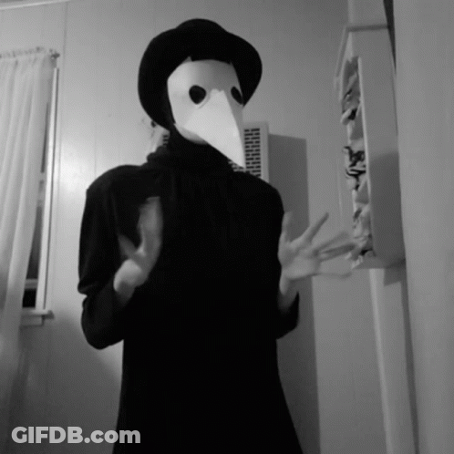 Black And White Photo Of Person In Bird Mask GIF